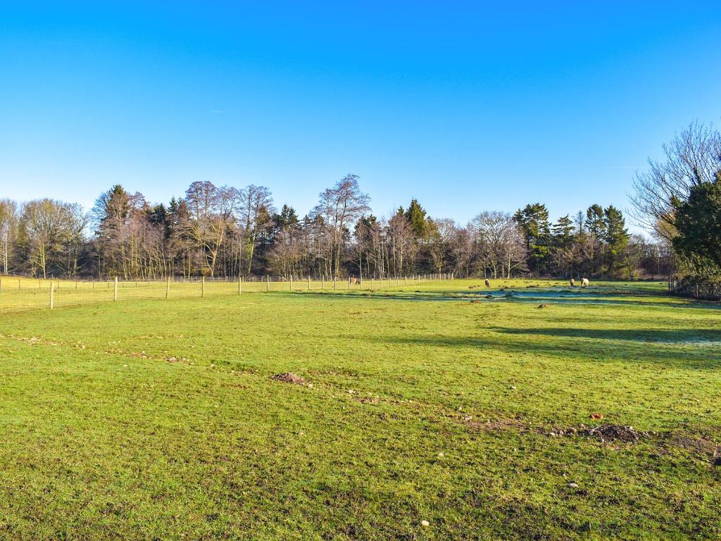 a large grass field with trees in the background at The Byre - Uk42872 in Burntwood