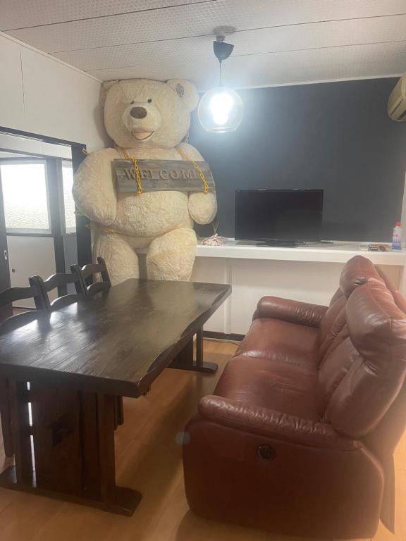 a giant teddy bear standing in a living room at FRIENDS in Futae