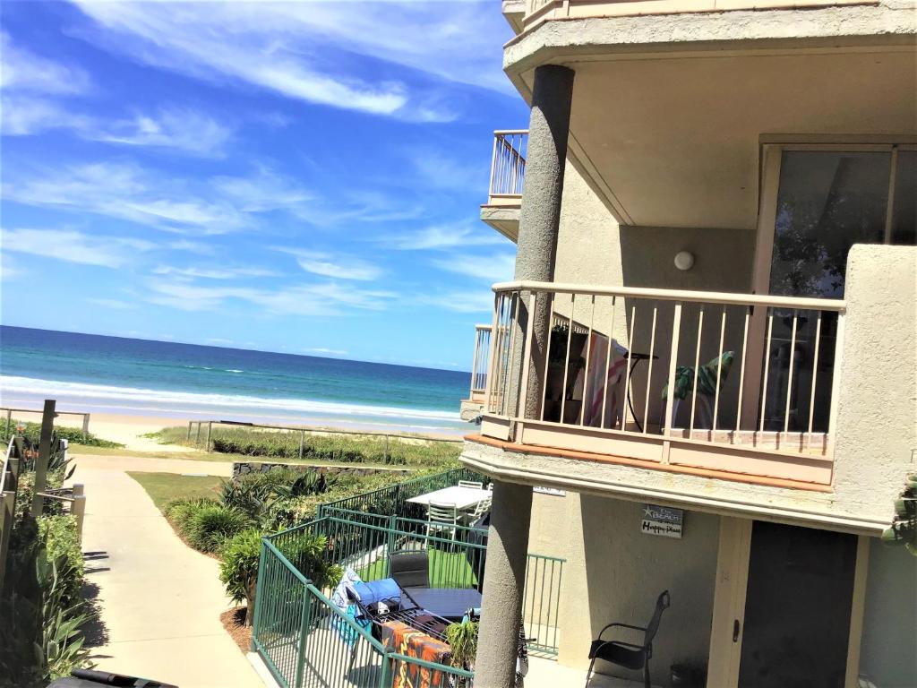 a balcony of a building with a view of the beach at Sanctuary Beach Resort in Gold Coast