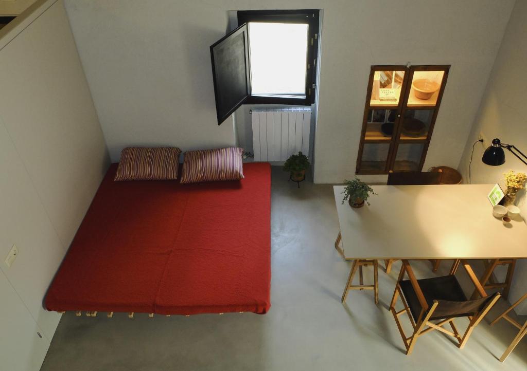 una sala de estar con una alfombra roja y una mesa en Ca L'Olier, en Montblanquet