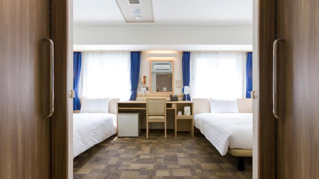 Postel nebo postele na pokoji v ubytování Toyoko Inn Sodegaura eki Kita guchi
