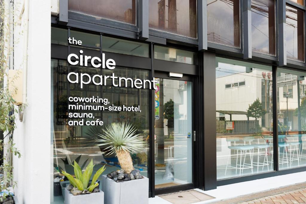 a store window with a sign for the circle apartment at the circle apartment in Shima