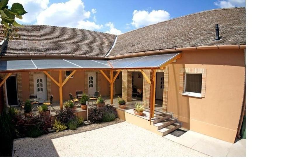 an image of a house with a roof at Borka Apartman in Makó