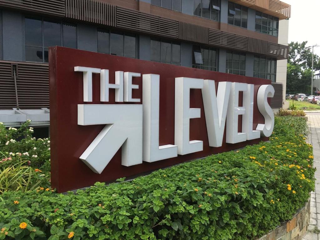 a large sign in front of a building at The Levels 2BR Condo Fully Interior Cosmo Living in Manila