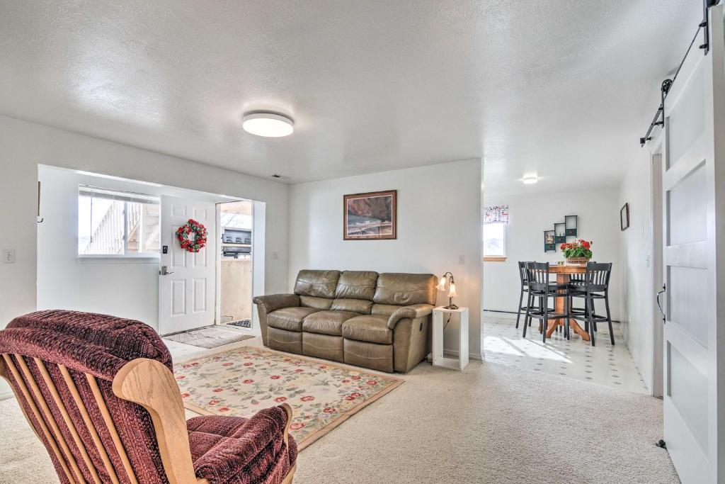 a living room with a couch and a table at Pet-Friendly Aurora House with Mountain Views! in Salina