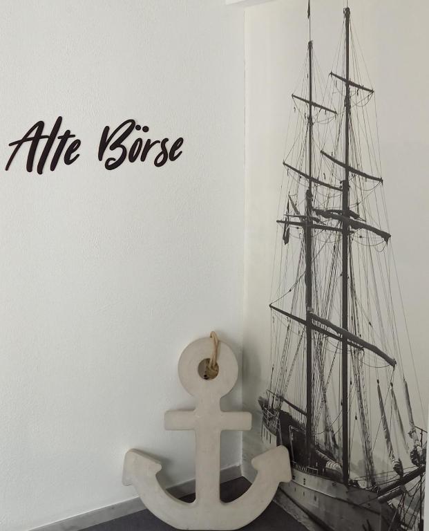 a model of a ship stenciled on a wall at Apartmenthaus Alte Börse in Carolinensiel