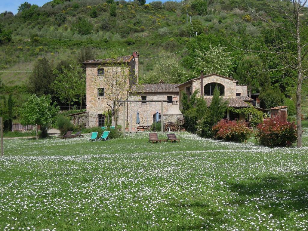 a large field of flowers in front of a house at Molino di Amarrante in Montaione