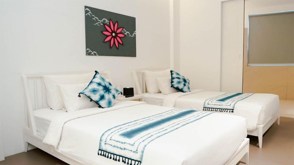Postel nebo postele na pokoji v ubytování K Gallery Hotel