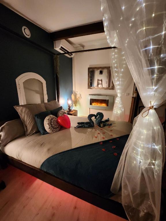 a bedroom with a large bed with a canopy at A l&#39;Orée des pins - Gite indépendant avec baignoire balnéo et Home Cinéma en sup - Voir info de l&#39;hôte in Cuges-les-Pins