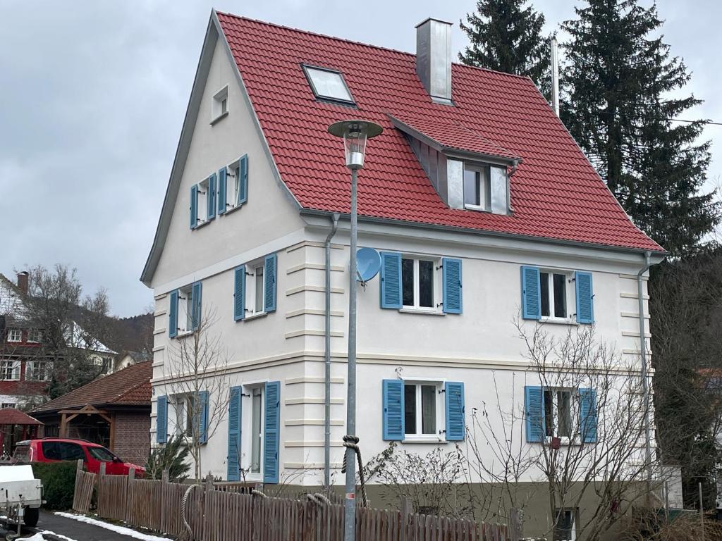 a large white house with a red roof at ZwergDackelAdlerHirsch in Beuron