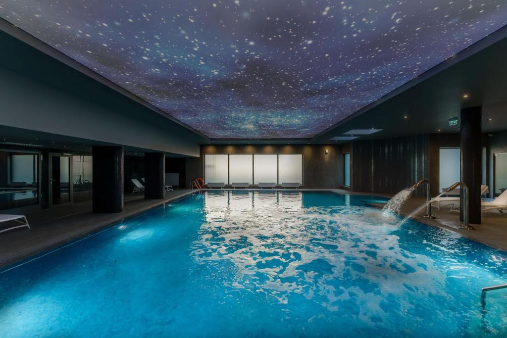 a swimming pool with a starry ceiling at FACTORY RESORT wellness & spa in Kołobrzeg