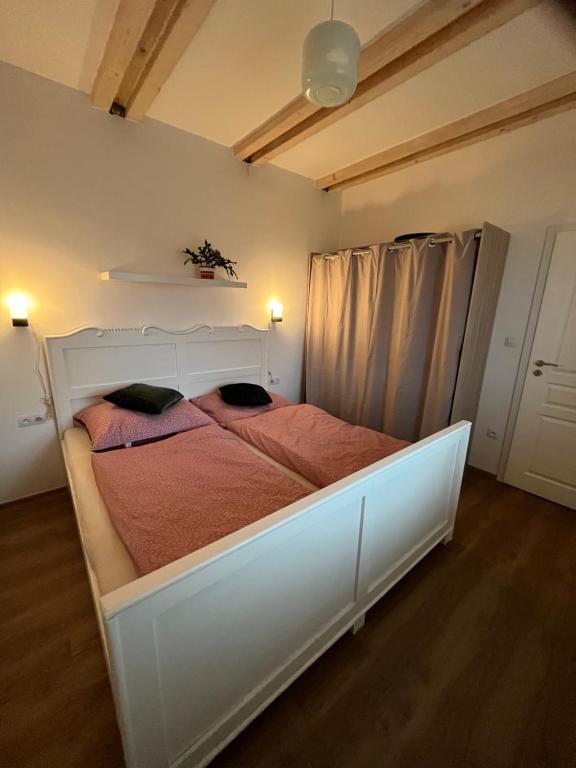 a bedroom with a large white bed in a room at Prázdninový dům Za Stodolou in Česká Ves