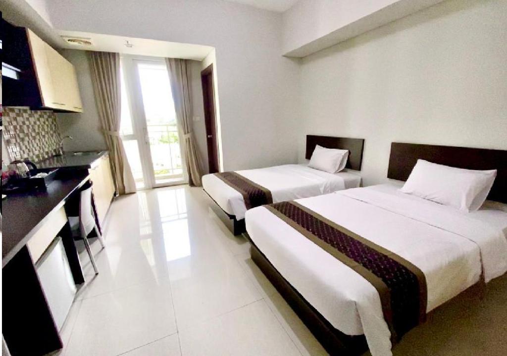 Postel nebo postele na pokoji v ubytování Skyland City Hotel Jatinangor