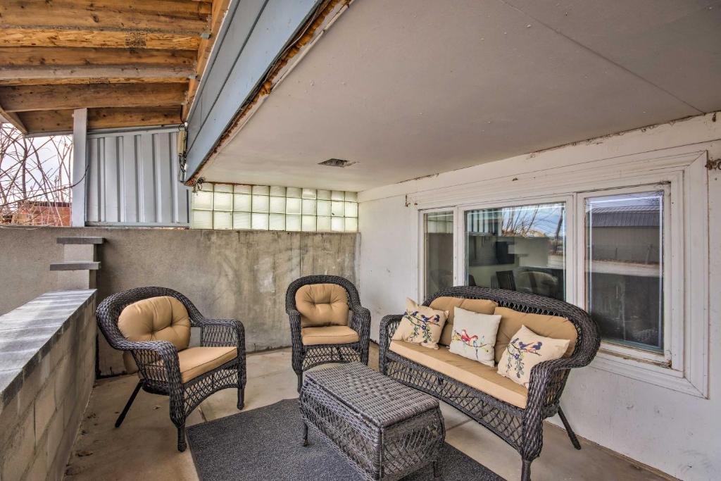 a porch with wicker chairs and a bench and windows at Billings Apartment with Fireplace and Smart TV in Billings