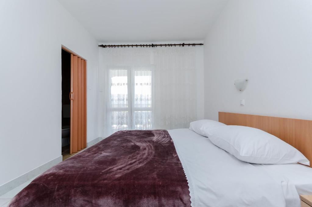Postel nebo postele na pokoji v ubytování Apartments Luce