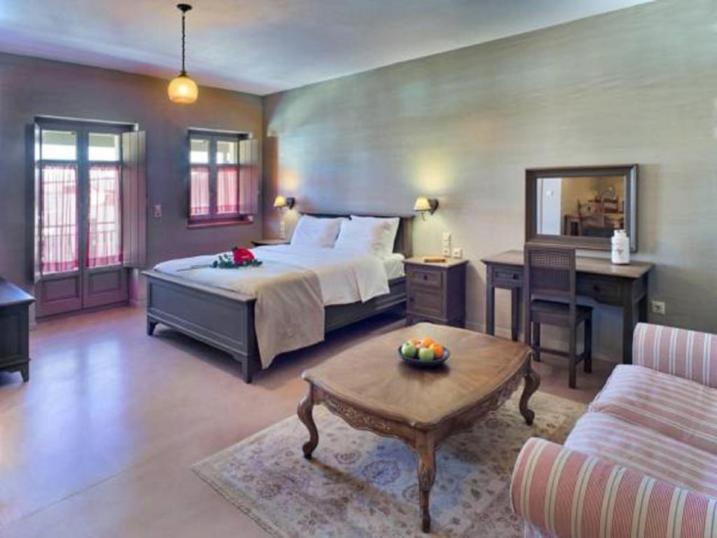 A bed or beds in a room at Haones Suites