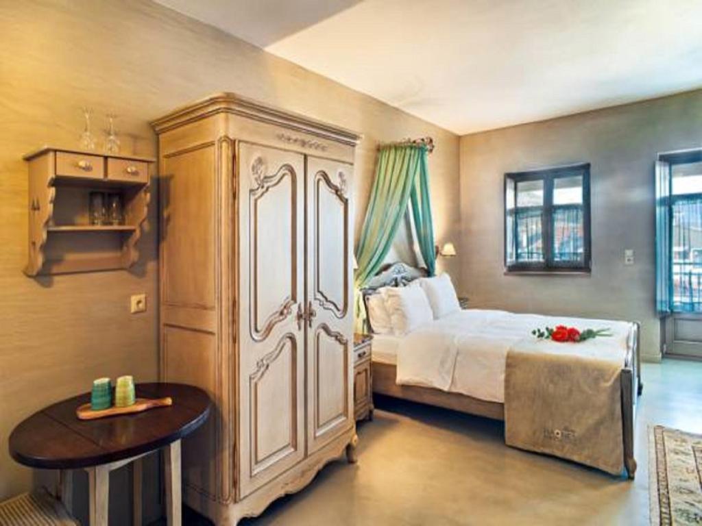 A bed or beds in a room at Haones Suites