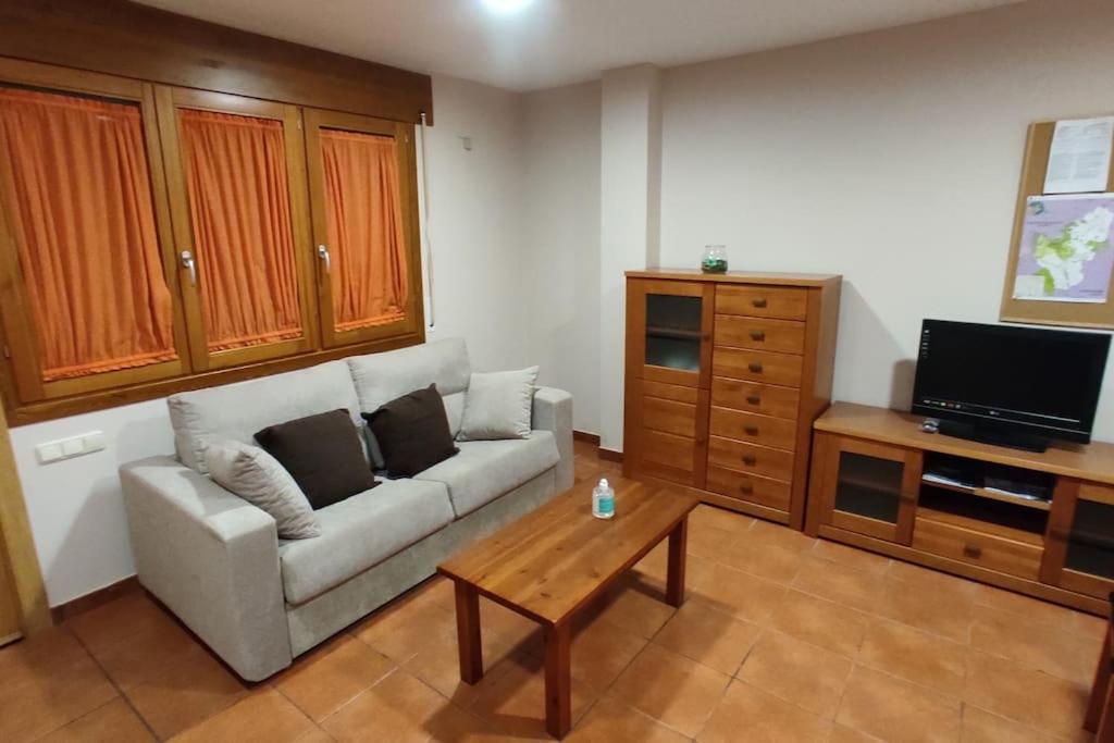 a living room with a couch and a coffee table at Pirineos como en casa in Bielsa