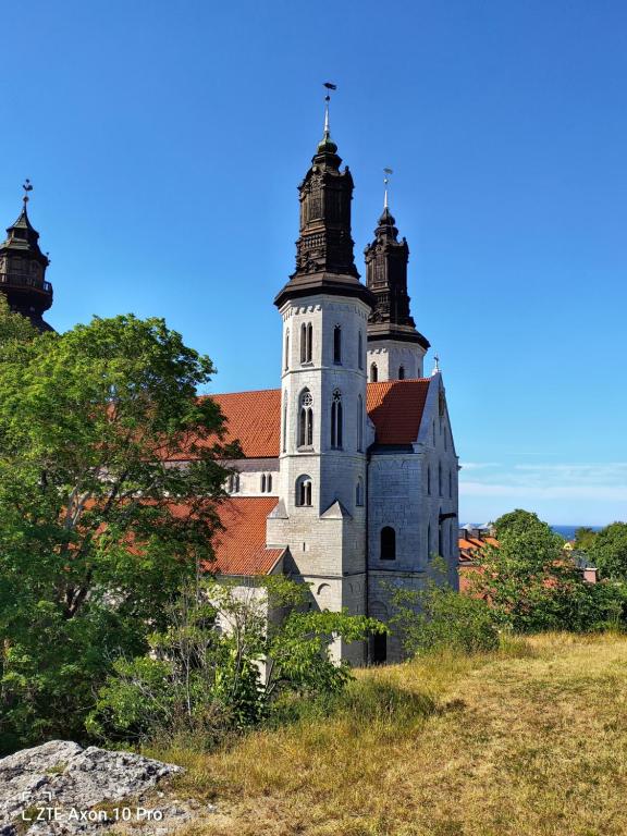 a building with two towers on top of a hill at Etta - Visby in Visby