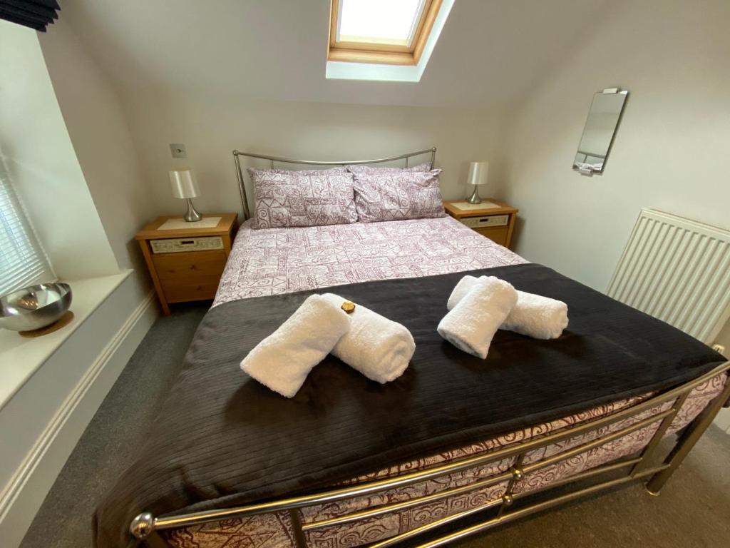 a bedroom with a bed with two pillows on it at Southover Beach in Woolacombe