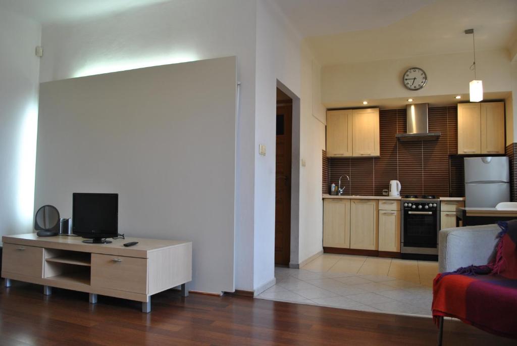 a living room with a tv and a kitchen at Apartament Gorczewska Przy Metrze in Warsaw
