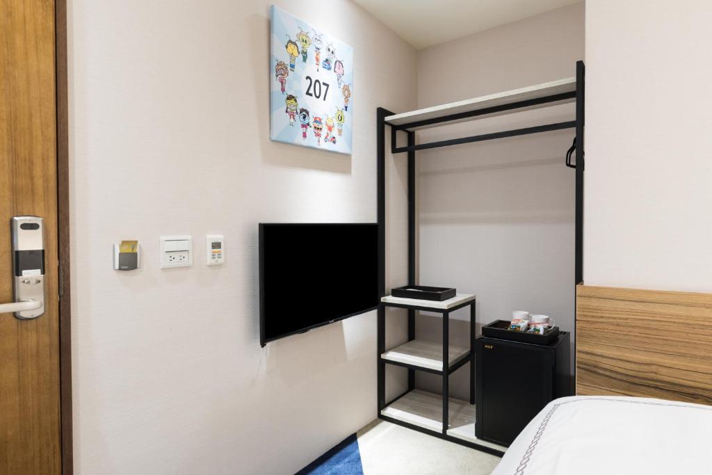 TV a/nebo společenská místnost v ubytování Tianli Hotel