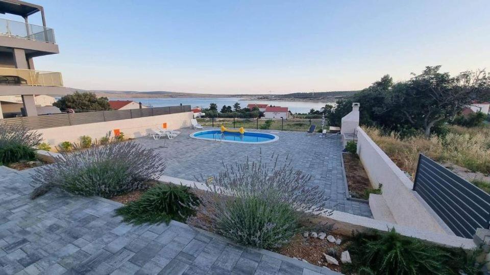 a backyard with a pool and a playground at Vila Cissa in Novalja