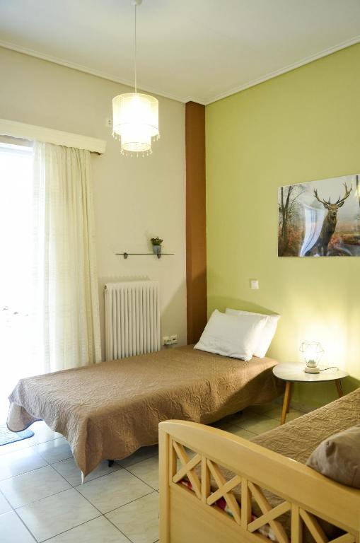 Posteľ alebo postele v izbe v ubytovaní Ariston Stay