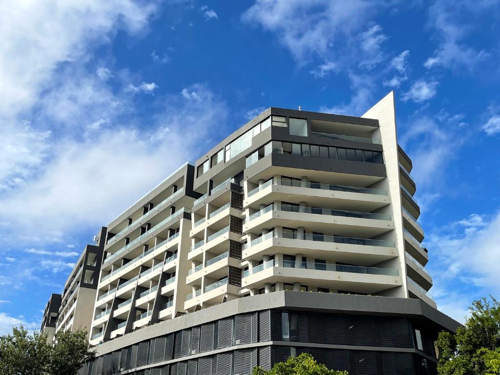 a tall building with a blue sky in the background at Newlands Peak Aparthotel by Totalstay in Cape Town