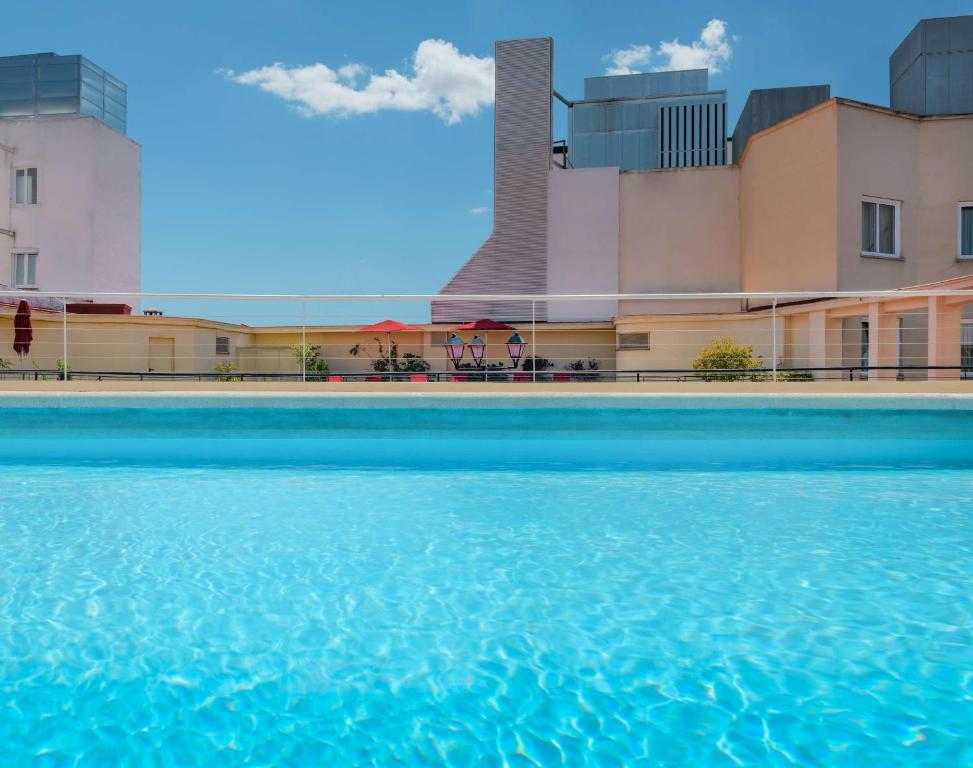 a pool of water in front of a building at NH Collection Madrid Colón in Madrid