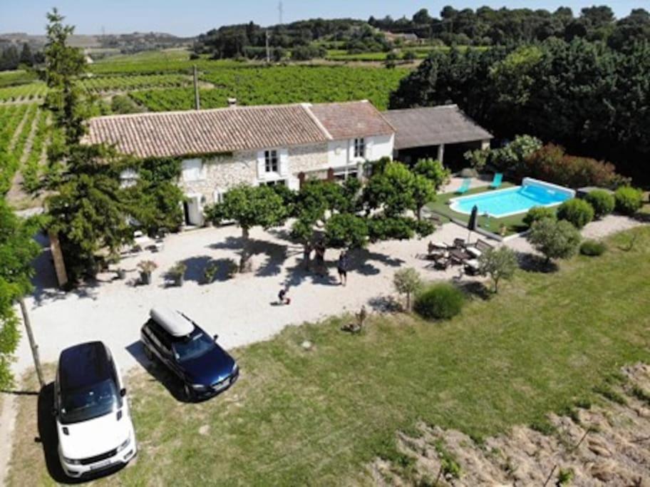- une vue aérienne sur une maison avec une voiture et une piscine dans l'établissement Mas 19e entièrement climatisé avec piscine à usage exclusif, à Roquemaure