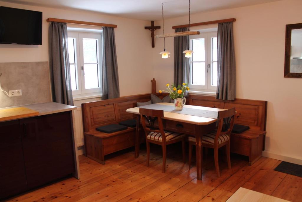 a dining room with a table and chairs at Holzer-Hof 