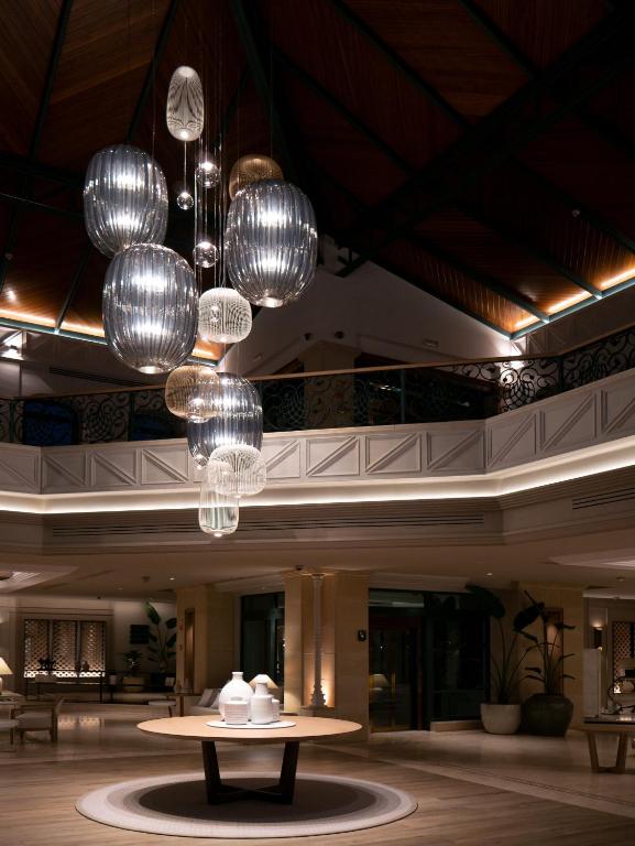 a lobby with a table and chandeliers at SH Villa Gadea in Altea