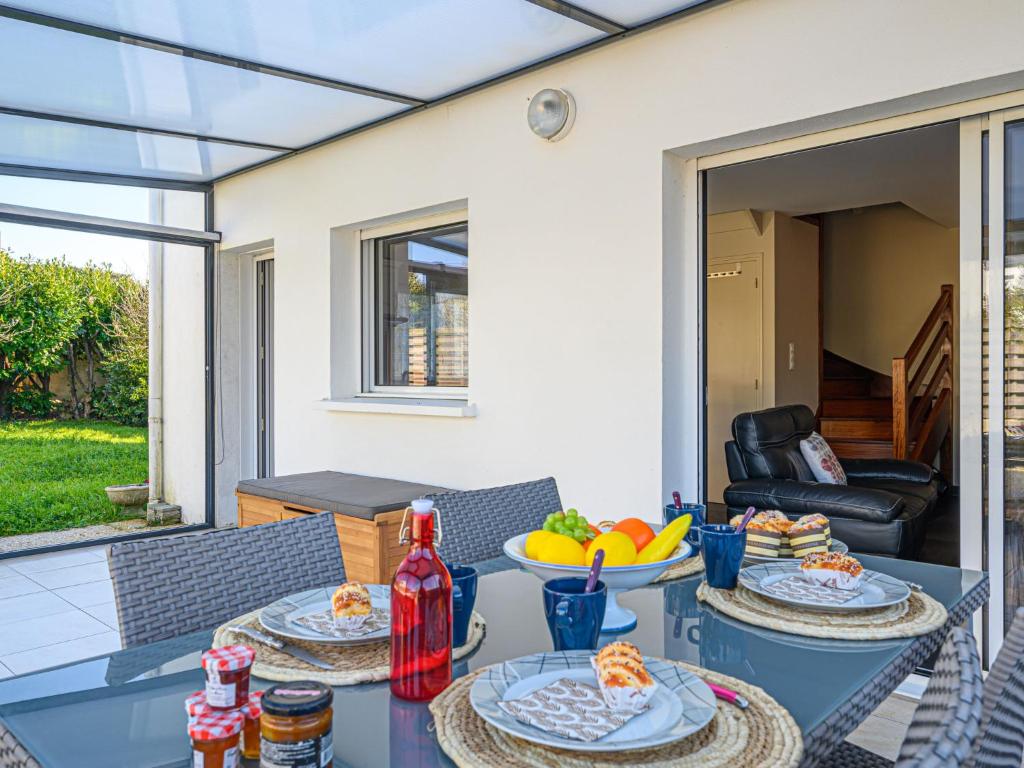 a patio table with two plates of food on it at Holiday Home Zal by Interhome in Saint-Pierre-Quiberon