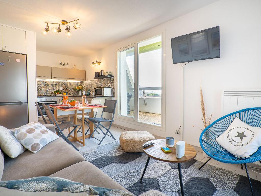 - un salon avec un canapé et une table avec des chaises dans l'établissement Apartment Bali by Interhome, à La Grande Motte