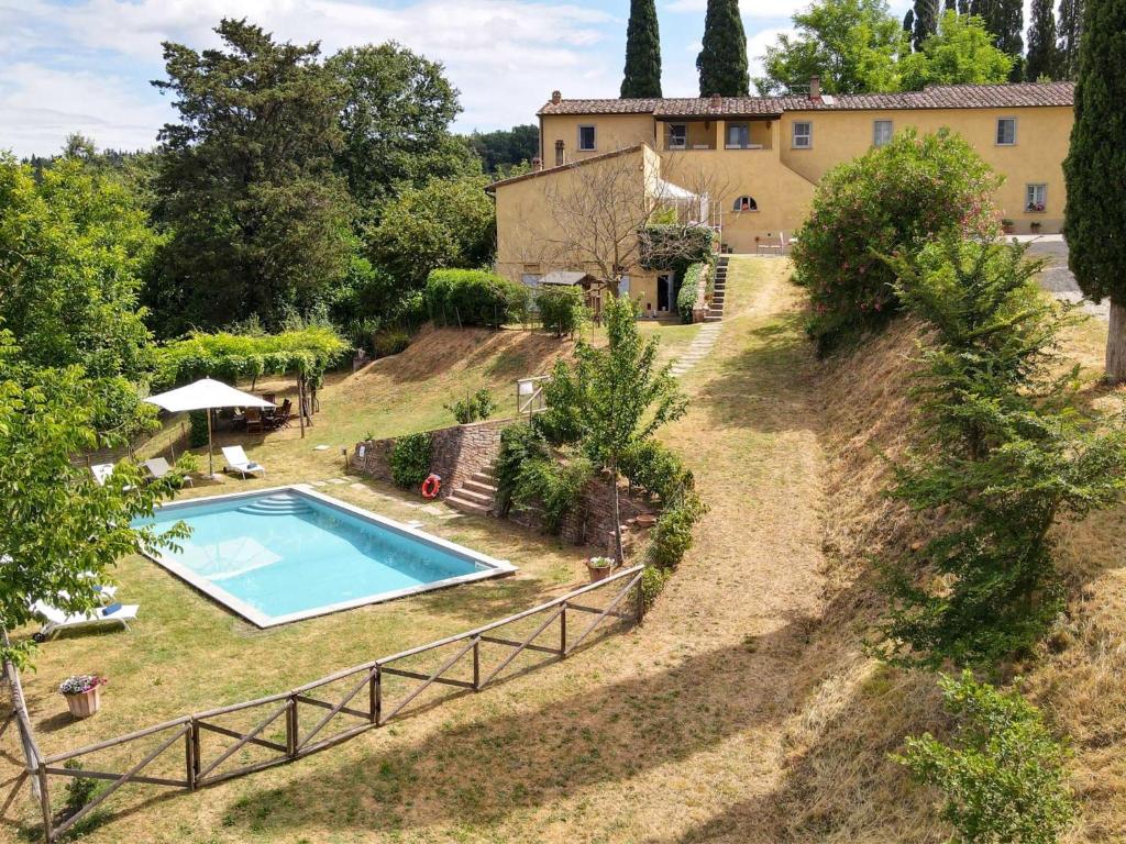 an estate with a swimming pool in front of a house at Villa Ghizzano by Interhome in Peccioli