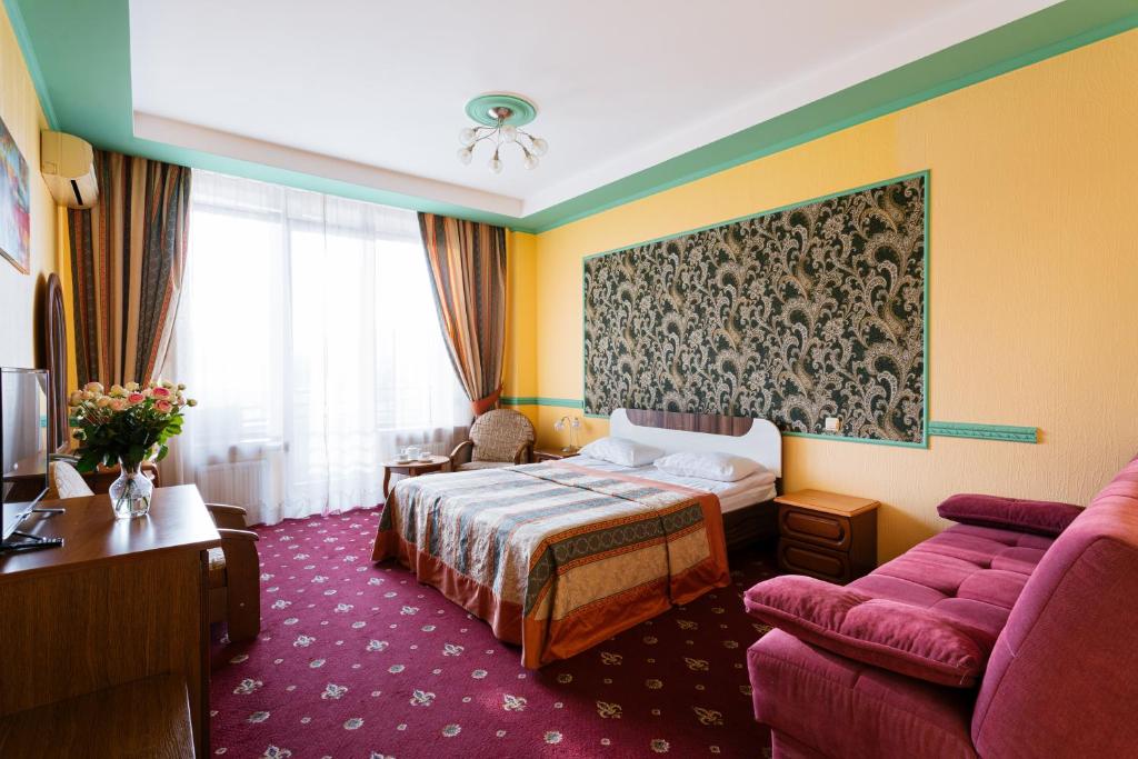 Кровать или кровати в номере Tiso Apart Hotel