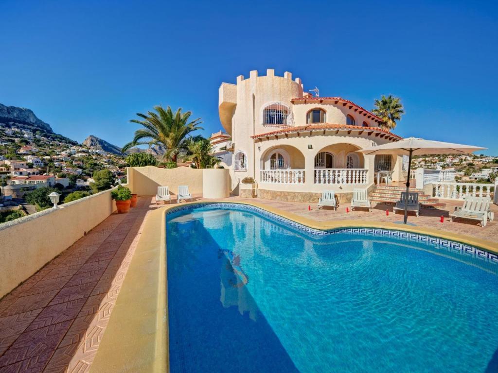 a villa with a swimming pool in front of a house at Villa Castillo by Interhome in La Canuta