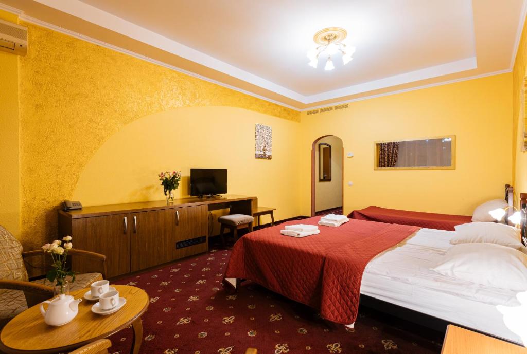 Postel nebo postele na pokoji v ubytování Tiso Apart Hotel