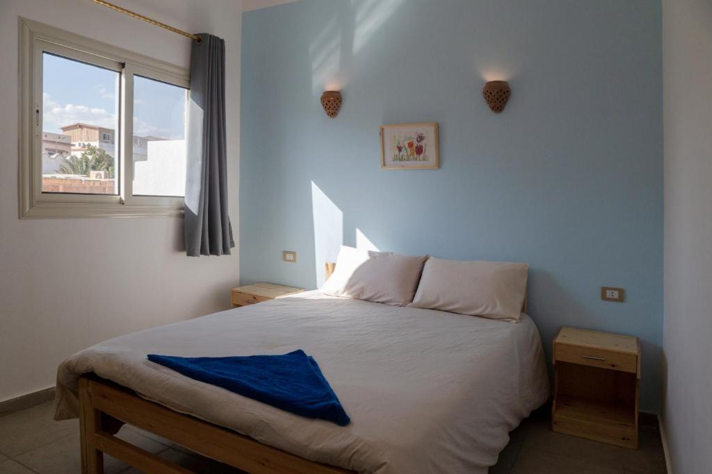 Postel nebo postele na pokoji v ubytování Al Deira Dahab Hotel