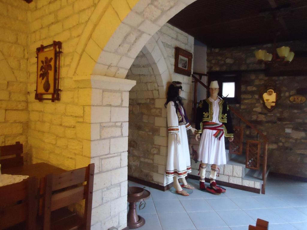 a man and a woman in uniform standing in a room at Hotel Klea in Berat