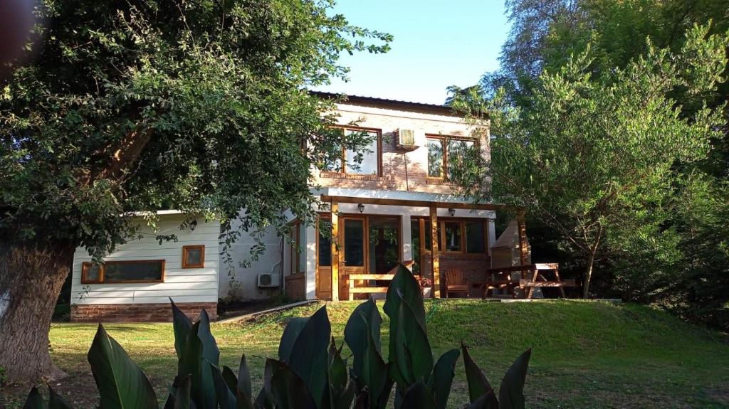 a house in the middle of a yard at Casa Golf in Sierra de los Padres