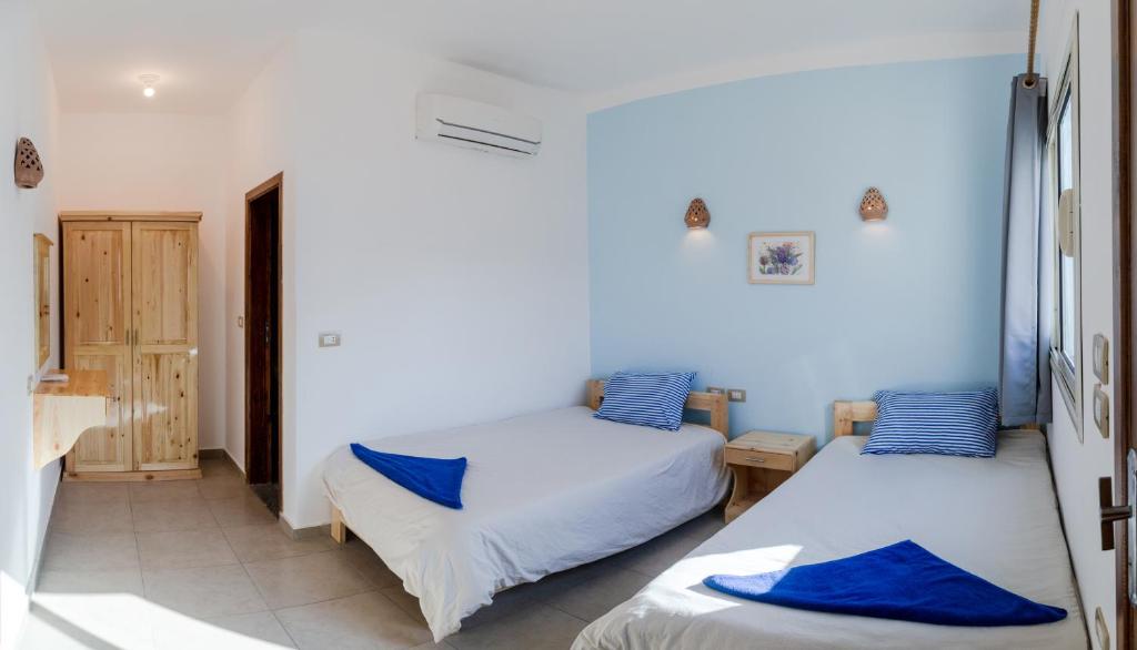 Postel nebo postele na pokoji v ubytování Al Deira Dahab Hotel