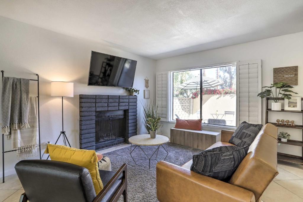 a living room with a couch and a fireplace at Palm Desert Vacation Rental with Pool Access! in Palm Desert