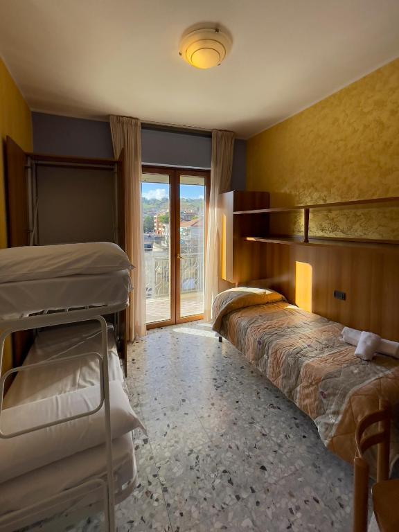 a room with two bunk beds and a window at La Lanterna in Silvi Marina