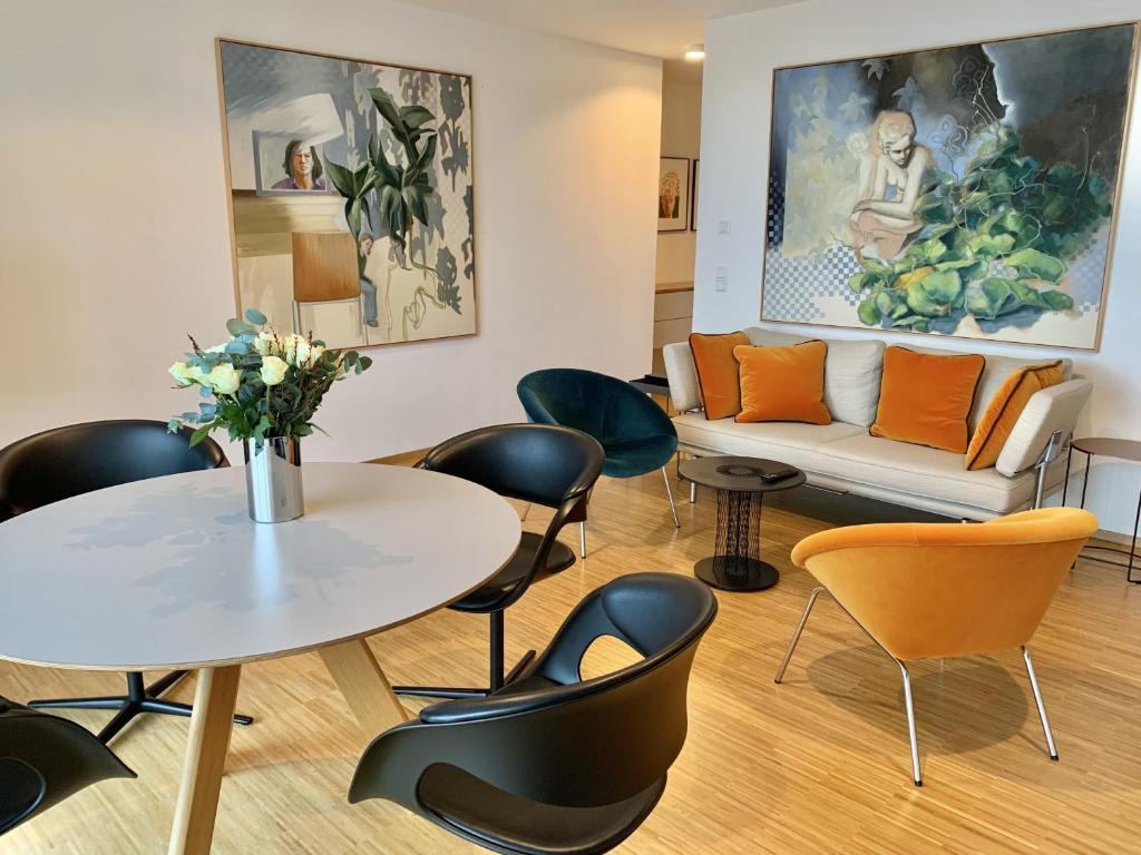 a living room with a table and chairs and a couch at Trilogie am See Wohnung Ranke in Stetten