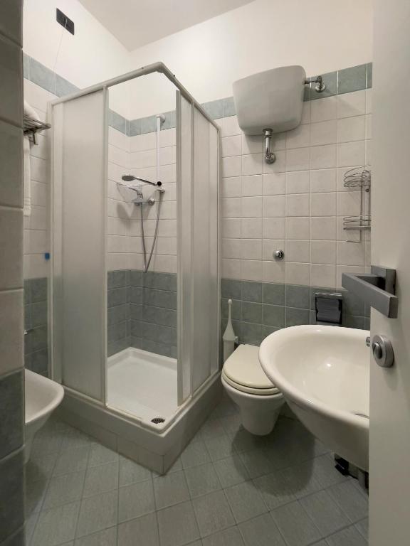 a bathroom with a shower and a toilet and a sink at La Lanterna in Silvi Marina