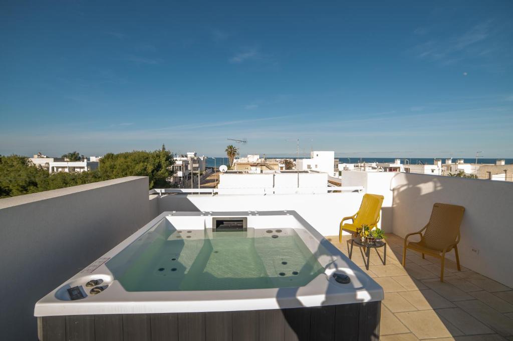 a hot tub on the roof of a balcony at VILLA PONENTE - Beach & Jacuzzi in Torre Santa Sabina