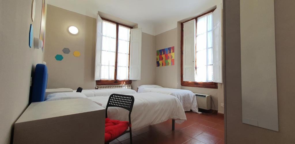 Łóżko lub łóżka w pokoju w obiekcie Hotel Genesi
