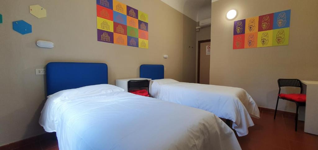 Łóżko lub łóżka w pokoju w obiekcie Hotel Genesi